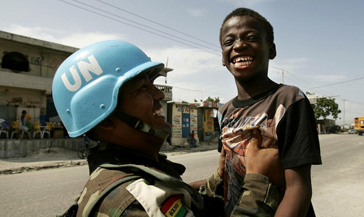 Peacekeeper Plays with Child in Cité Soleil, Haiti. Creative Commons. Some rights reserved. Photo by United Nations.