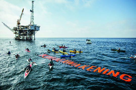The Santa Barbara chapter of Surfrider, Santa Barbara Channelkeeper, the Environmental Defense Center, and Patagonia hold a paddle-out to raise awareness for four bills moving through the California legislature to prevent future spills like the 2015 Refugio oil spill. Goleta, California. Tim Davis